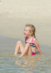 Little girl having fun on the beach.