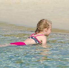 Little girl relaxing in the ocean.