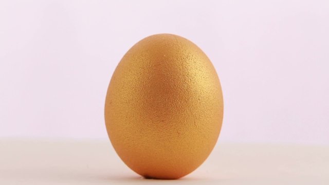 Golden Easter egg isolated over white background