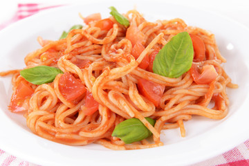 Pasta with tomato sauce on plate on table close-up