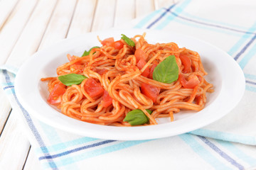 Pasta with tomato sauce on plate on table close-up