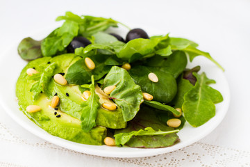 Green salad with avocado and arugula