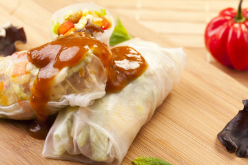 Portion of spring rolls on a bamboo board