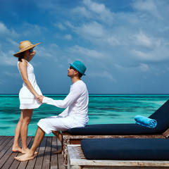 Couple on a beach jetty at Maldives