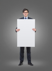 Businessman holding a blank poster