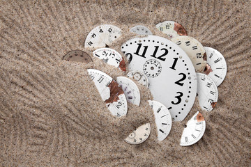 Antique watch faces in the sand. Lost time concept.
