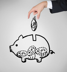 Piggy bank and a hand