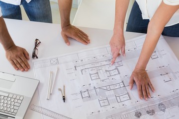 Casual architecture team working together at desk