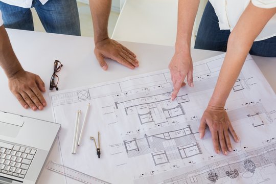 Casual architecture team working together at desk