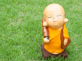 Statue of serenity novice on green grass