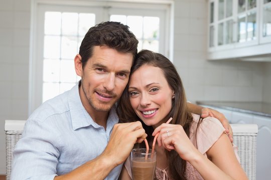 Loving Young Couple Sharing A Drink