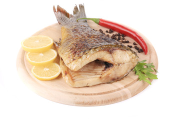 Grilled carp with lemon and peppers.