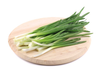 Green onions on the board.