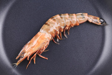 Raw tiger shrimp on frying pan.