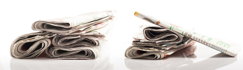 Various newspapers over white background