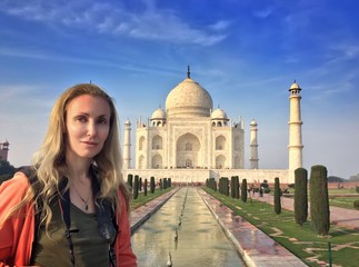 European woman against Taj Mahal