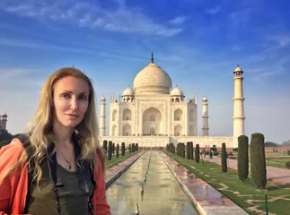 Tuinposter European woman against Taj Mahal © Konstantin Kulikov