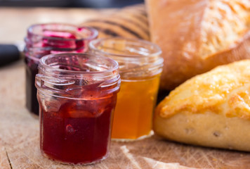 bread rolls with jars of jam