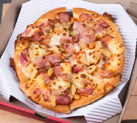 Tasty pizza in box on white