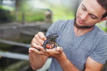 Farmer on frog farm in Bali