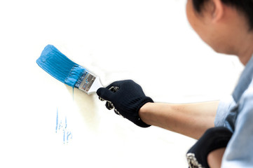 Blue paint splashing out of brush. Isolated on white background