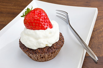 chocolate muffin with whipped cream and strawberry