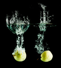 oriental pear in water on a black background.