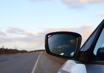Fototapeta premium reflection seen through car side mirror - sunset