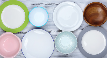 Different tableware on wooden background