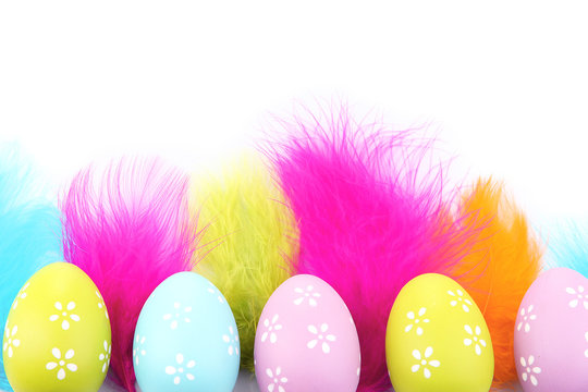 Easter eggs and decorative feathers, isolated on white