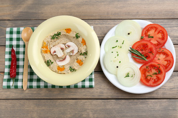 Bowl of tasty fresh hummus with tomatoes