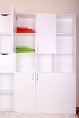 White shelves with colored towels close up