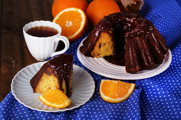Tasty homemade pie with oranges on table close-up