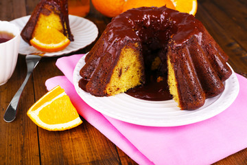 Tasty homemade pie with oranges on table close-up
