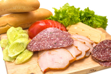 Sandwich ingredients on a wooden board against white background