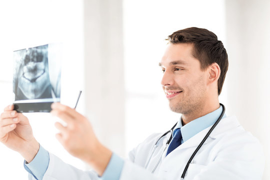 male doctor or dentist with x-ray
