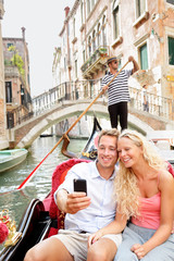 Travel couple in Venice on Gondole ride romance