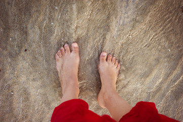 Closeup of female feet at the beach