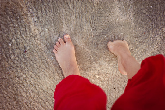 Closeup of female feet at the beach