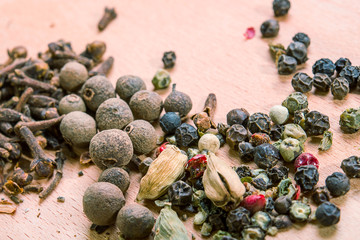 mixed spices on wooden board