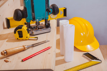 set of carpenter tools on steps of wooden ladder