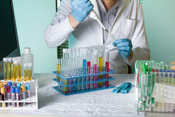 doctor pipetting sample for study in tube