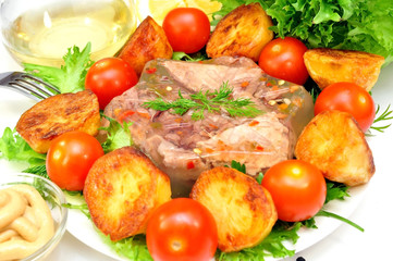 Aspic from meat with roasted potatoes and fresh vegetables