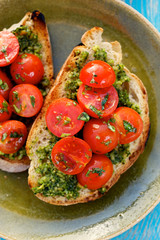 Bruschetta with fresh cherry tomatoes and herb pesto