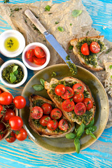 Bruschetta with fresh cherry tomatoes and herb pesto