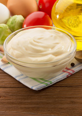 mayonnaise sauce in bowl on wood