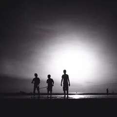 Zelfklevend Fotobehang silhouette of three male friends walking on the beach © nasruleffendy
