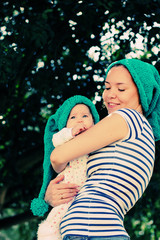 Portrait of happy loving mother and her baby outdoors