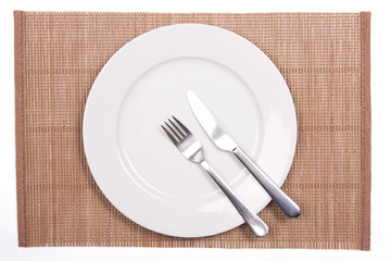 White plate on a bamboo mat