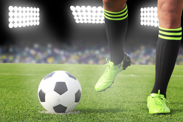 Soccer ball on field in stadium at night